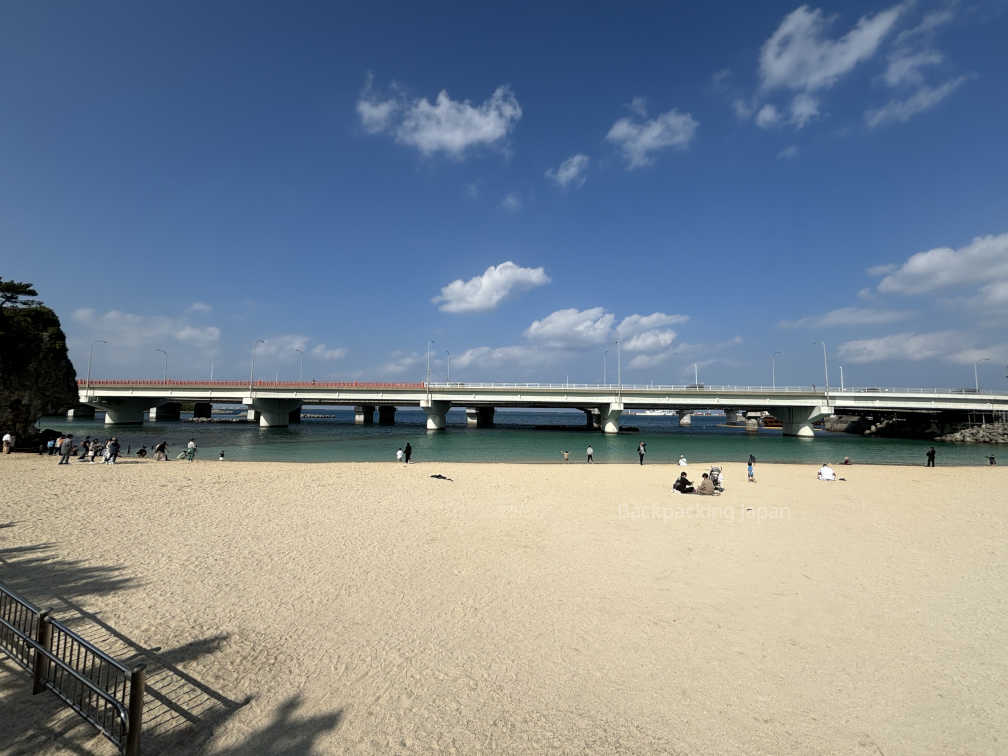 Beach next to the shrine which looks out at the ocean and a bridge